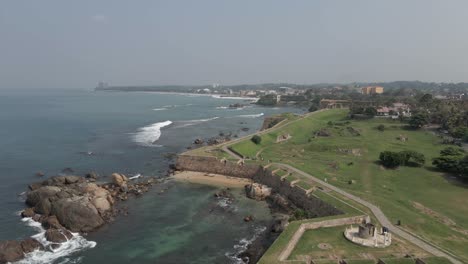 Aerial-flyover-of-rampart-fortifications-of-Galle-Fort-wall,-Sri-Lanka