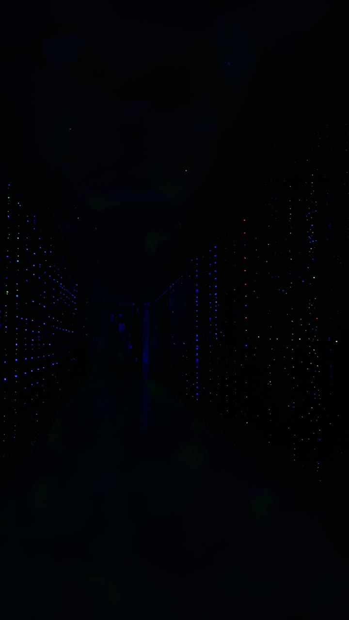 Vertical video: Starting camera sliding down server corridor, revealing blue lights and rack LEDs