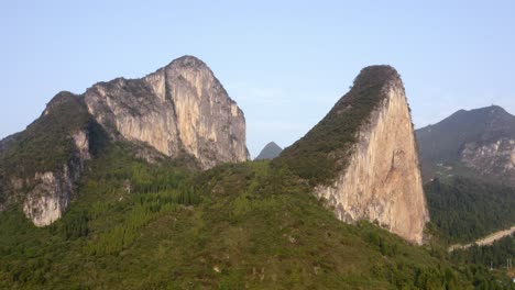 chinese karst mountain landscape on sunny day, aerial reveal