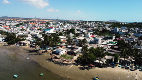 coiffed trees on historic coconut jungle vietnam makes place for polluted beach dirty boats, and life in vietnamese countyside, backwards drone dolly shot