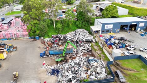 aerial view of scrapyard with active machinery