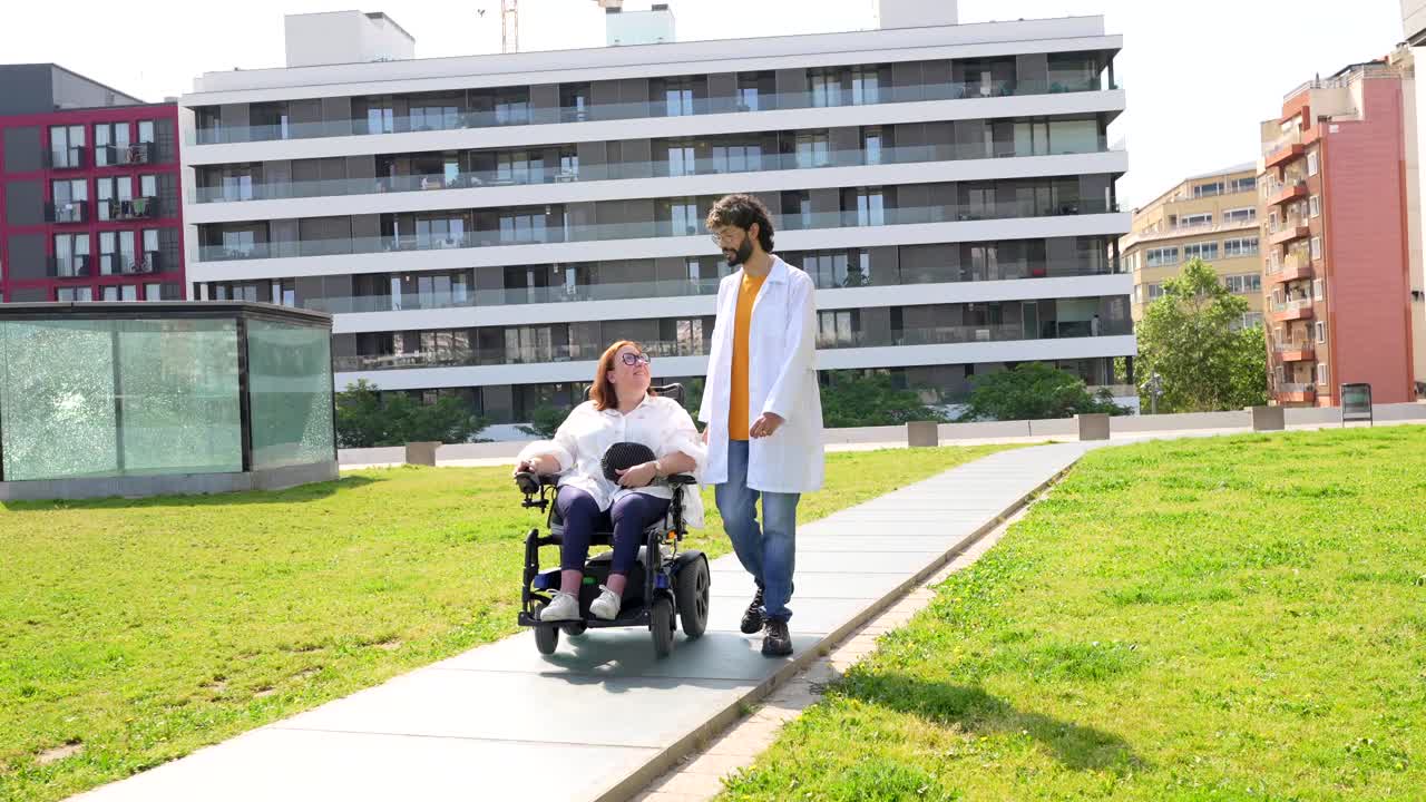 Doctor assisting woman in wheelchair outdoors