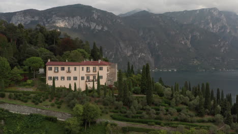 Aerial-of-hotel-with-beautiful-green-gardens-on-the-edge-of-mountain