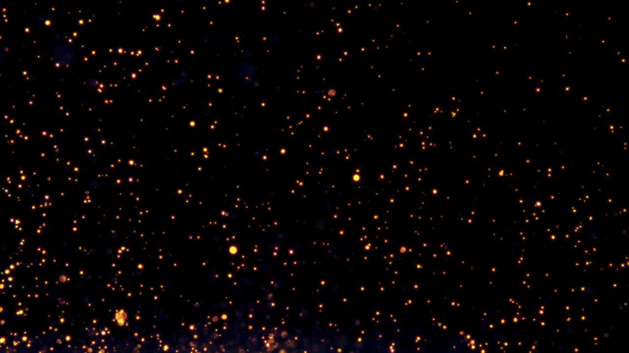 Glow particles flow in the air on black background, glitter sparkling dust