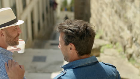 back view of happy guy couple going down stairs in street