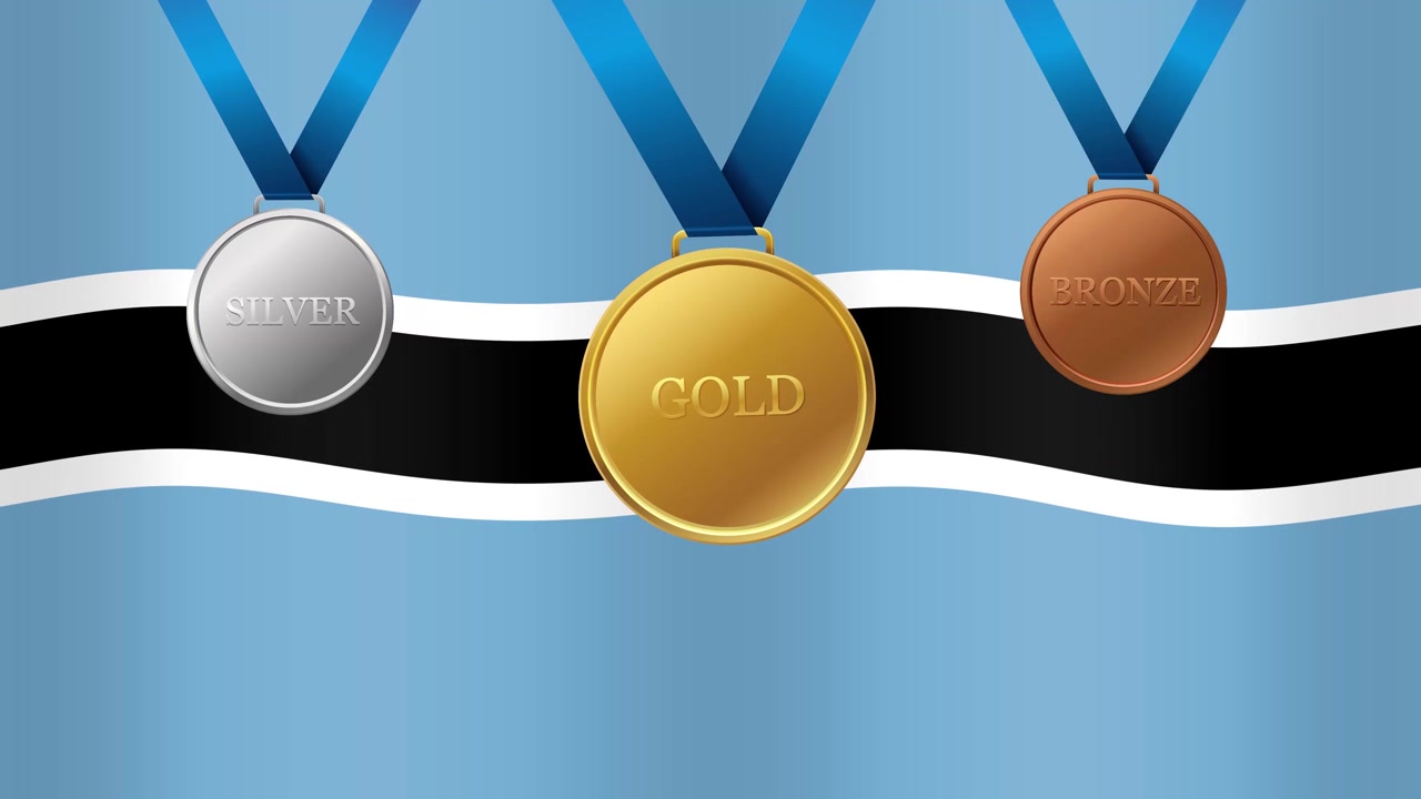 Medaglie sportive animate d'oro, d'argento e di bronzo appese sopra una bandiera nazionale del Botswana che sventola