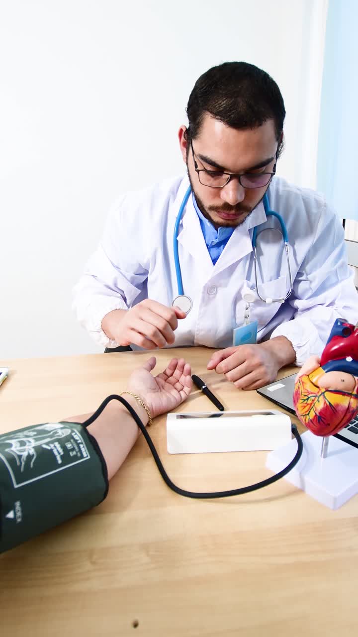 Doctor checking patient arterial blood pressure in hospital.