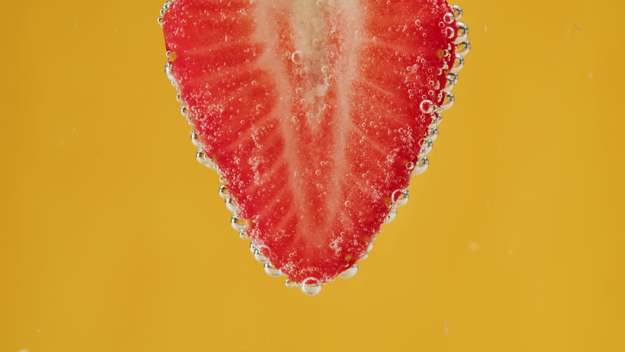 Strawberry Slice in Water with Bubbles