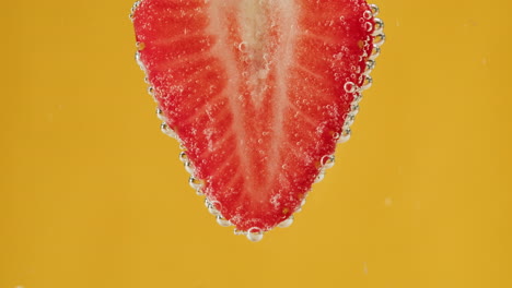strawberry slice in water with bubbles