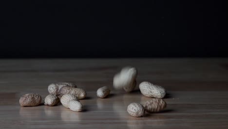 peanuts dropping on table in slow motion