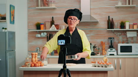 elderly woman filming cooking vlog