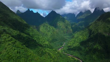 teahupoo vallee de tautira river valley bay vaitepiha village tahiti island french polynesia aerial drone jagged mountain aorai peak canyon aorai taiarapu taravao north shore sunny clouds circle right