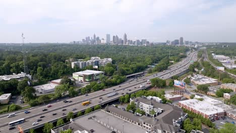 atlanta, georgia skyline and freeway traffic with drone video wide shot moving left to right