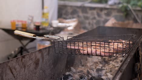 street chef prepares juicy fried sausages on the grill, outdoor barbecue. 4k