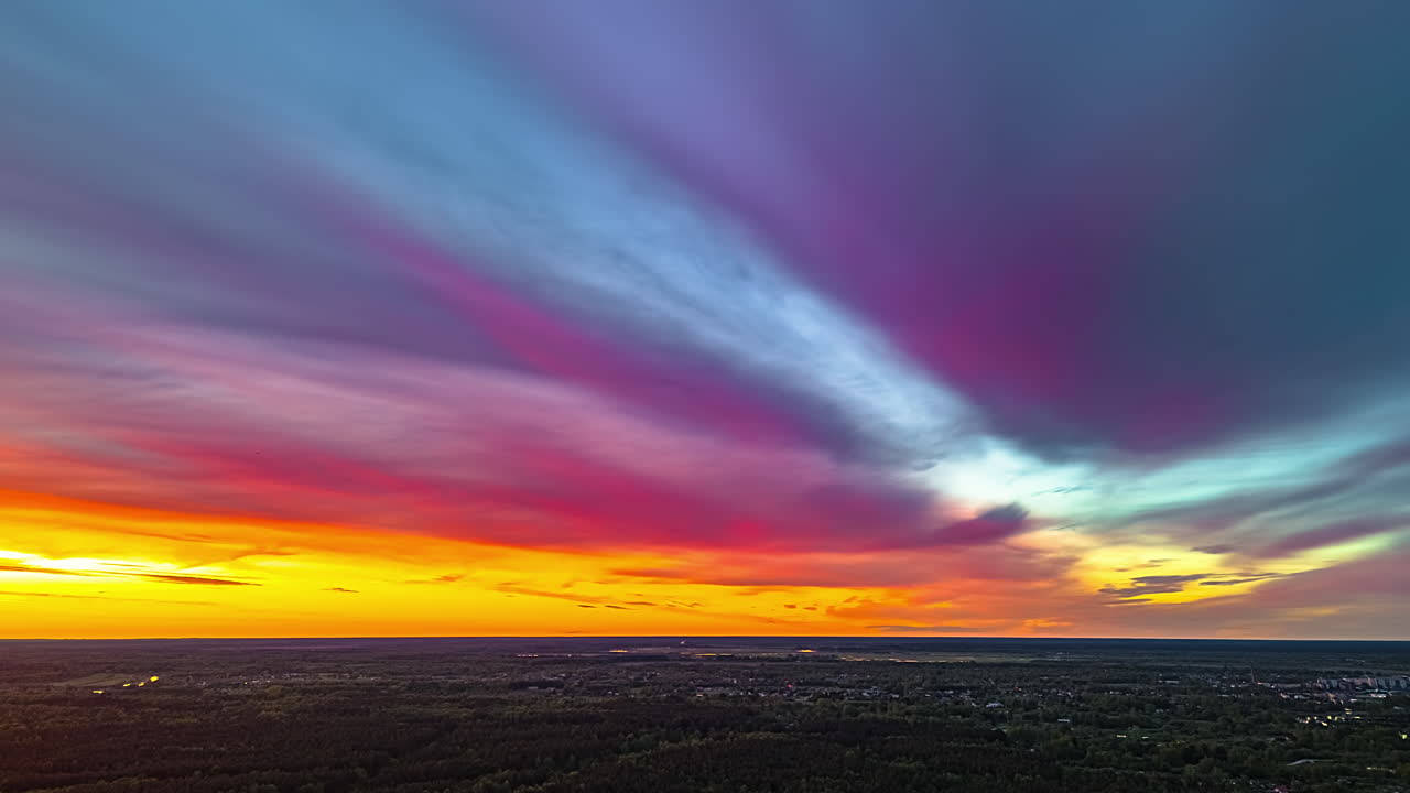 Amazing colorful aerial time lapse above a forest and villages in the European countryside - high altitude aerial time lapse