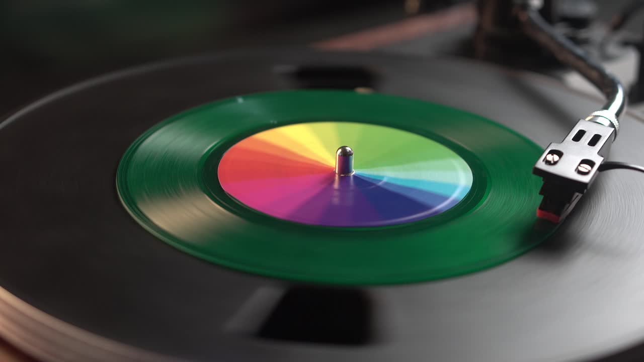 Starting Playback of Green Single Vinyl Record on Turntable, Close Up