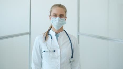 female doctor wearing mask and white coat
