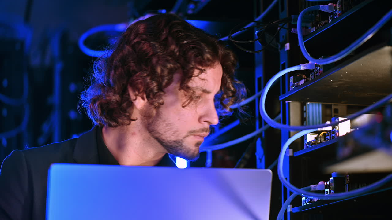 Man analysing data in a server room