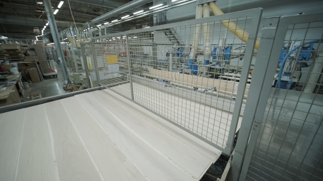 Automated Wood Panel Moving on Conveyor Belt in Modern Factory