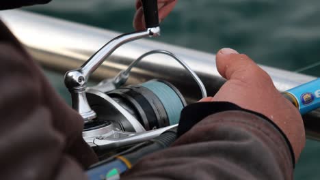 fisherman adjusting fishing reel