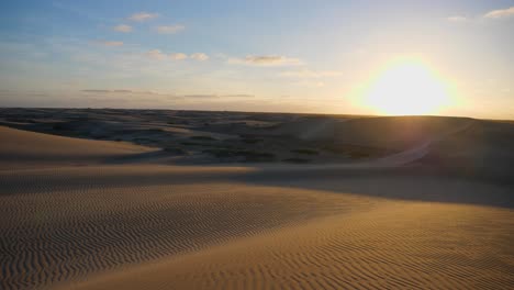 tilting up shot, scenic view of desert sand in adolfo lopez mateos baja california sur, mexico, sun rise in the background