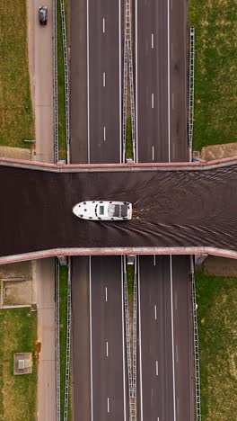 highway bridge over canal with boat
