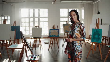 a woman paints in an art studio
