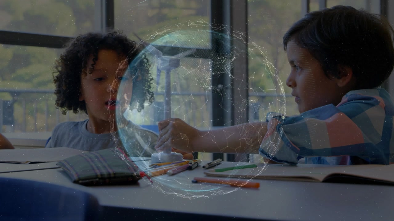Right boy reaching, picking and passing to left boy as overlay globe linking turbine for STEM