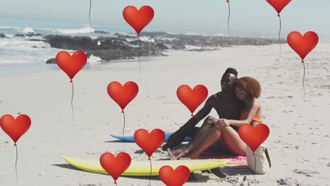 Animation-of-heart-icons-over-couple-in-love-with-surfboards-on-beach