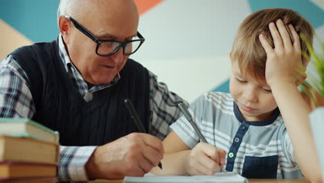grandfather and grandson studying together