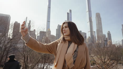 woman taking a selfie in central park, new york city