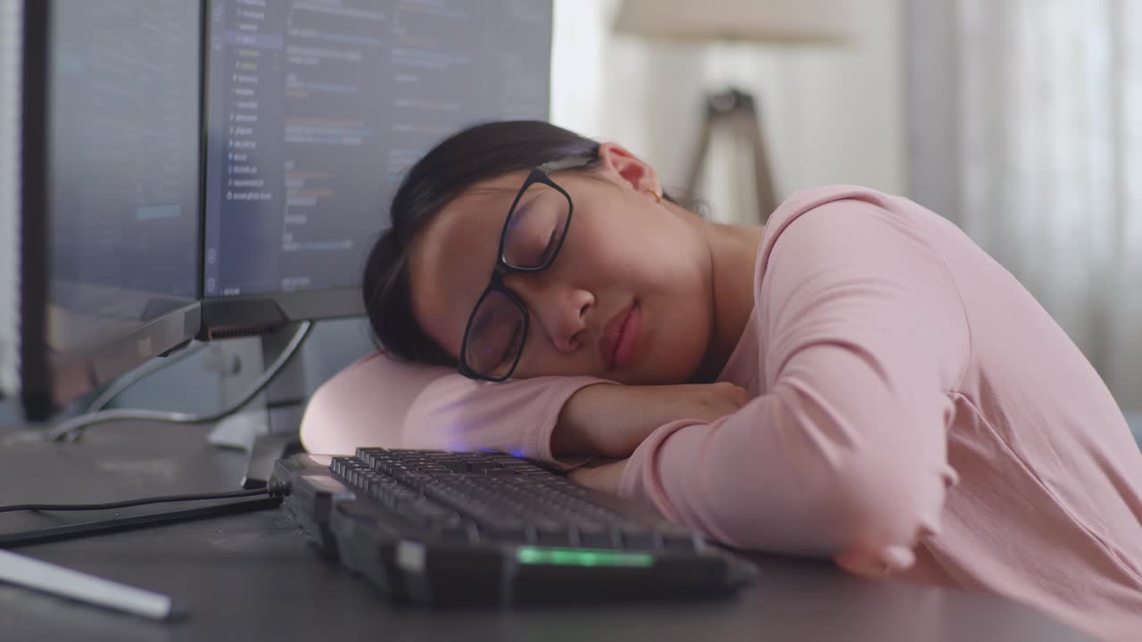 Tired Programmer Napping at Desk