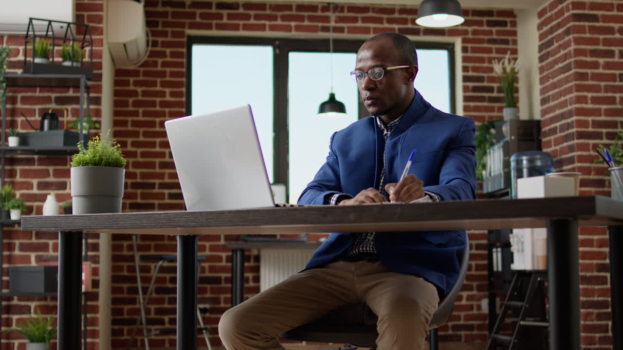 Office worker analyzing research information on laptop