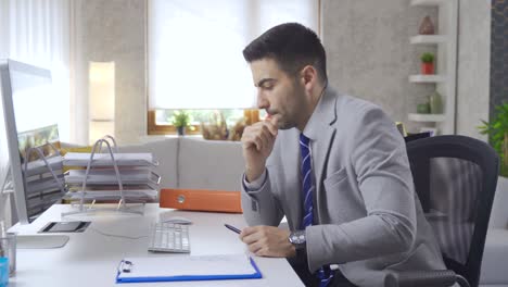 pensive businessman using computer wins success excited.