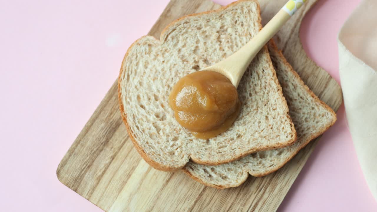 Kaya spread on a spoon on table ,