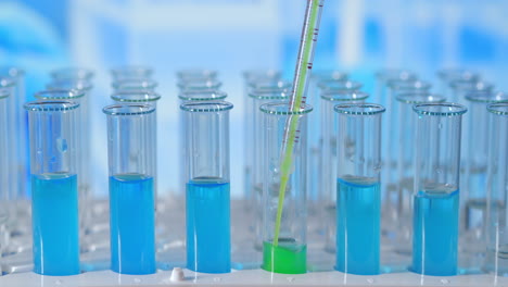 lab biochemist dripping oil into test tube with plant organic cosmetology study. high quality 4k footage