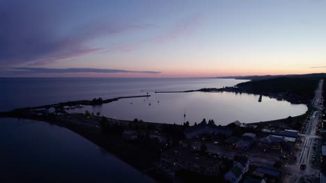 Aerial-drone-shot-of-a-large-boat-harbor-during-a-colorful-sunset