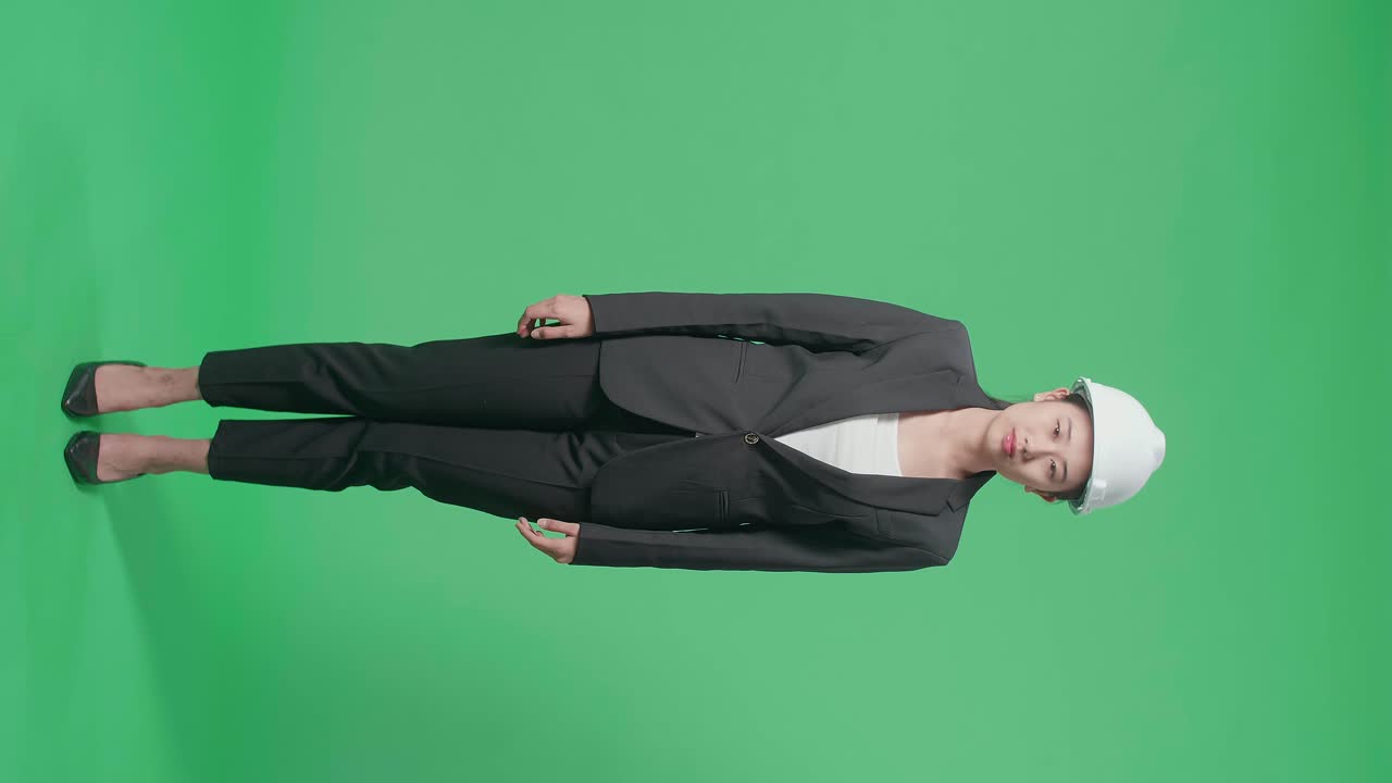 Full Body Of Upset Asian Female Engineer With Safety Helmet Shaking Head In The Green Screen Studio