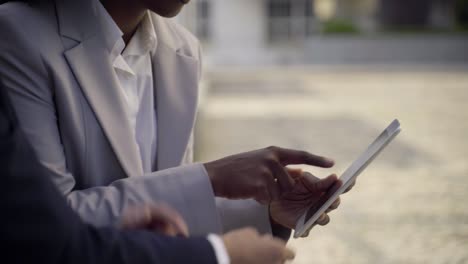 cropped shot of two businesswomen using tablet