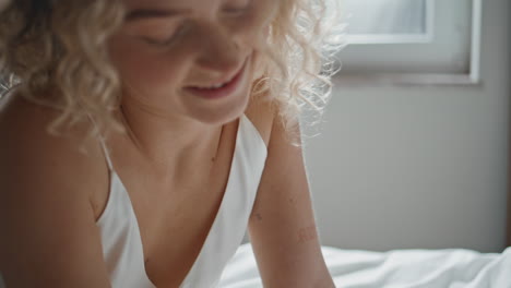 hand running soft bedding in morning closeup. smiling woman