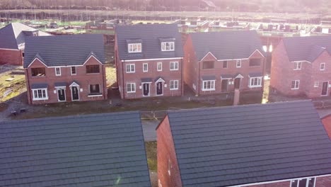 unfinished modern townhouse property development construction site aerial view dolly right