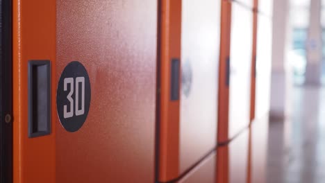 a row of orange lockers in a hallway