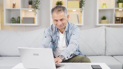 Man-looking-at-laptop-making-positive-gesture.