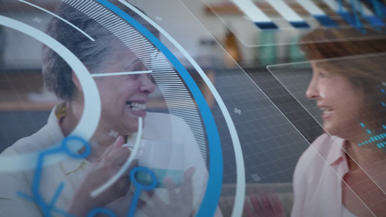 Two women on sofa, right speaking, left sipping mugs, home chatting, blue overlay moving over them