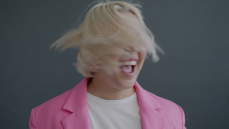 excited woman in pink blazer
