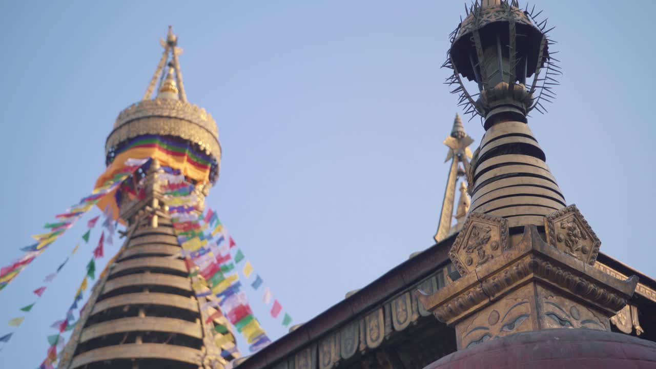 Golden Tower Of The Swayambhunath Temple In Kathmandu, Nepal Against Clear Blue Sky - panning shot