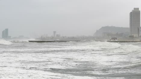 surge with big waves, strong wind and poor visibility. slow motion.