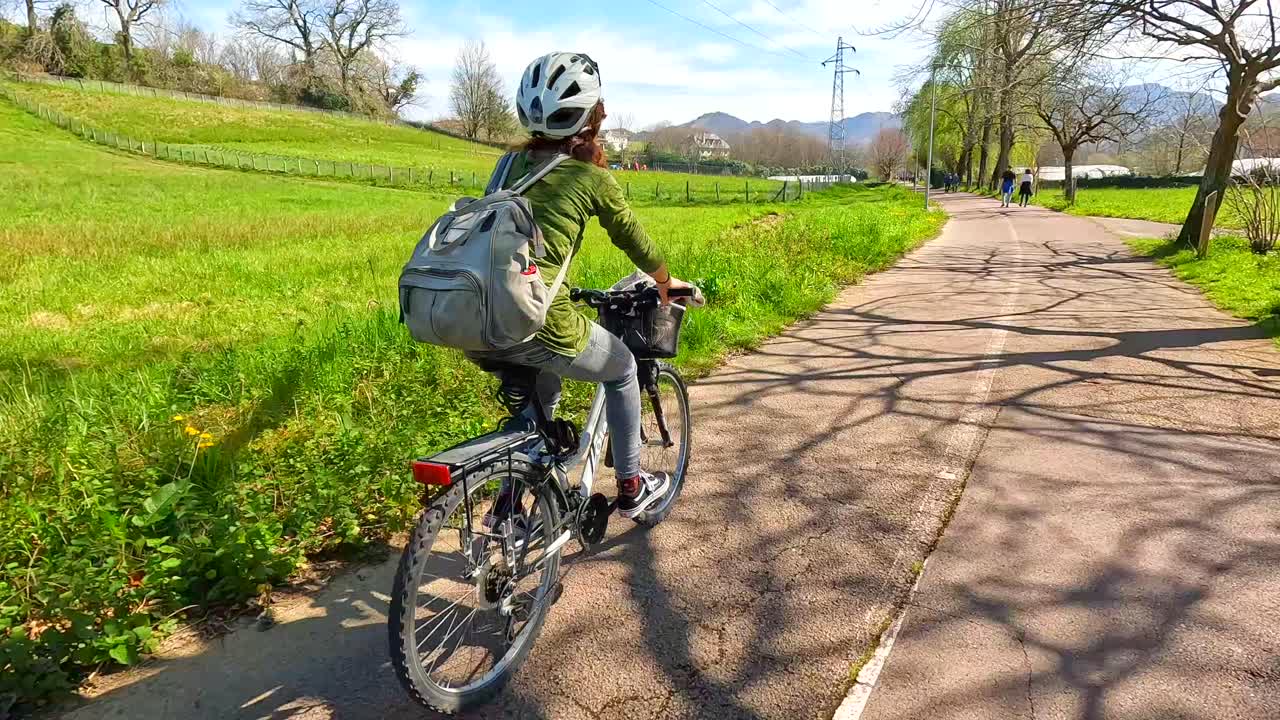 Woman Cycling on Bike Path