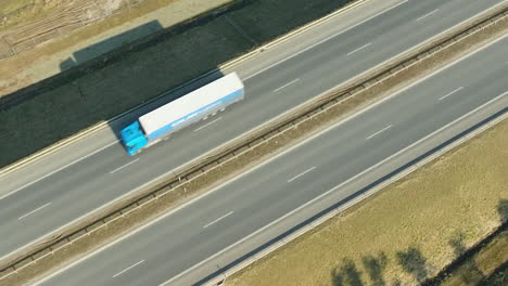 Top-down-view-of-a-large-blue-and-white-truck-on-a-highway