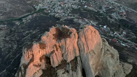 pena de bernal monolith in the beautiful colonial village of bernal, queretaro, mexico - aerial shot